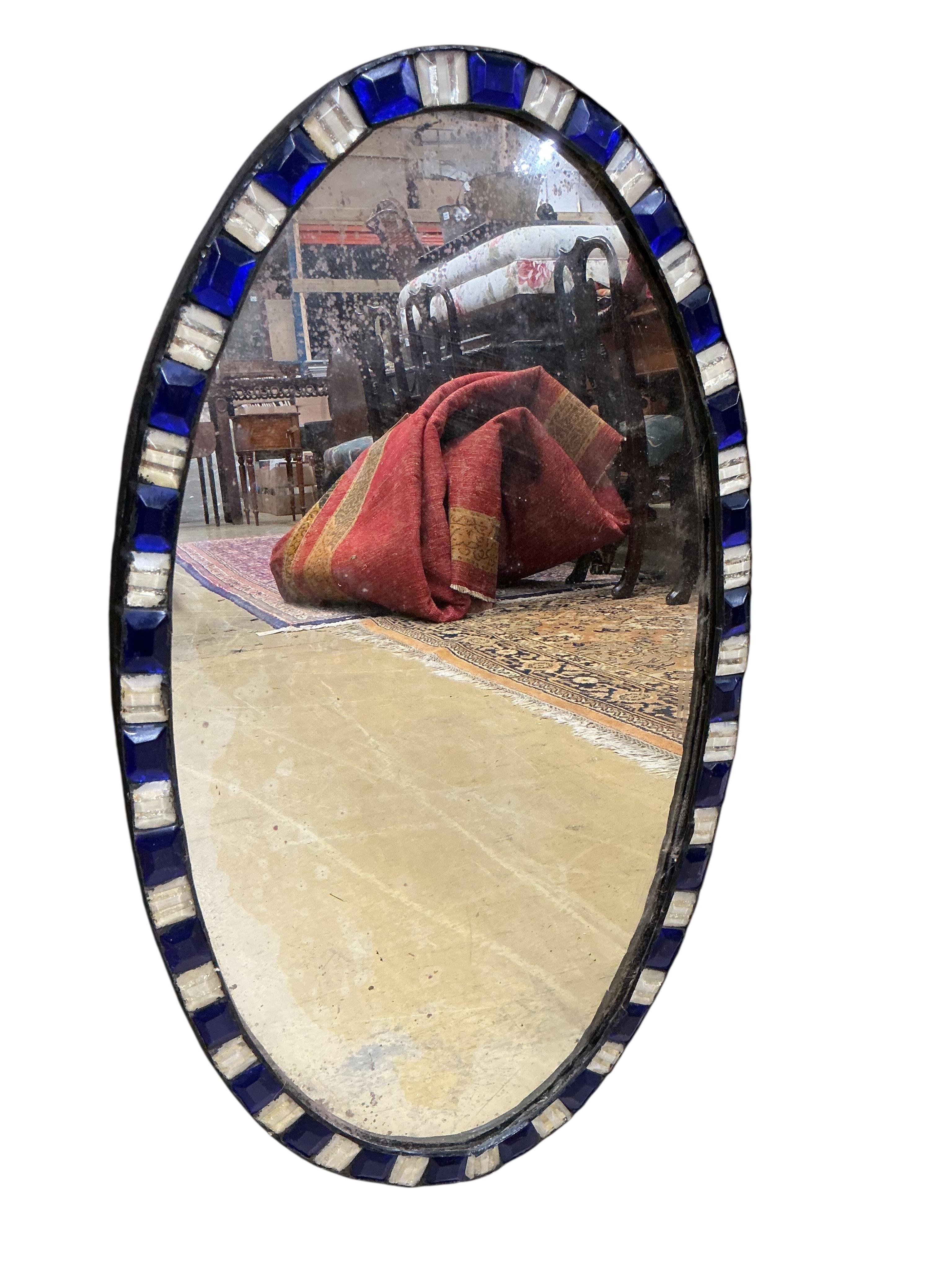 An oval Irish style wall mirror, width 37cm, height 65cm